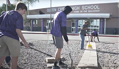 Volunteers cleaning outside of QCHS